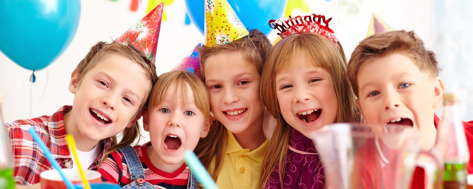 Group of adorable kids looking at camera at birthday party